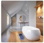 Nowoczesna łazienka na poddaszu z wolnostojącą wanną i umywalką w minimalistycznym stylu.